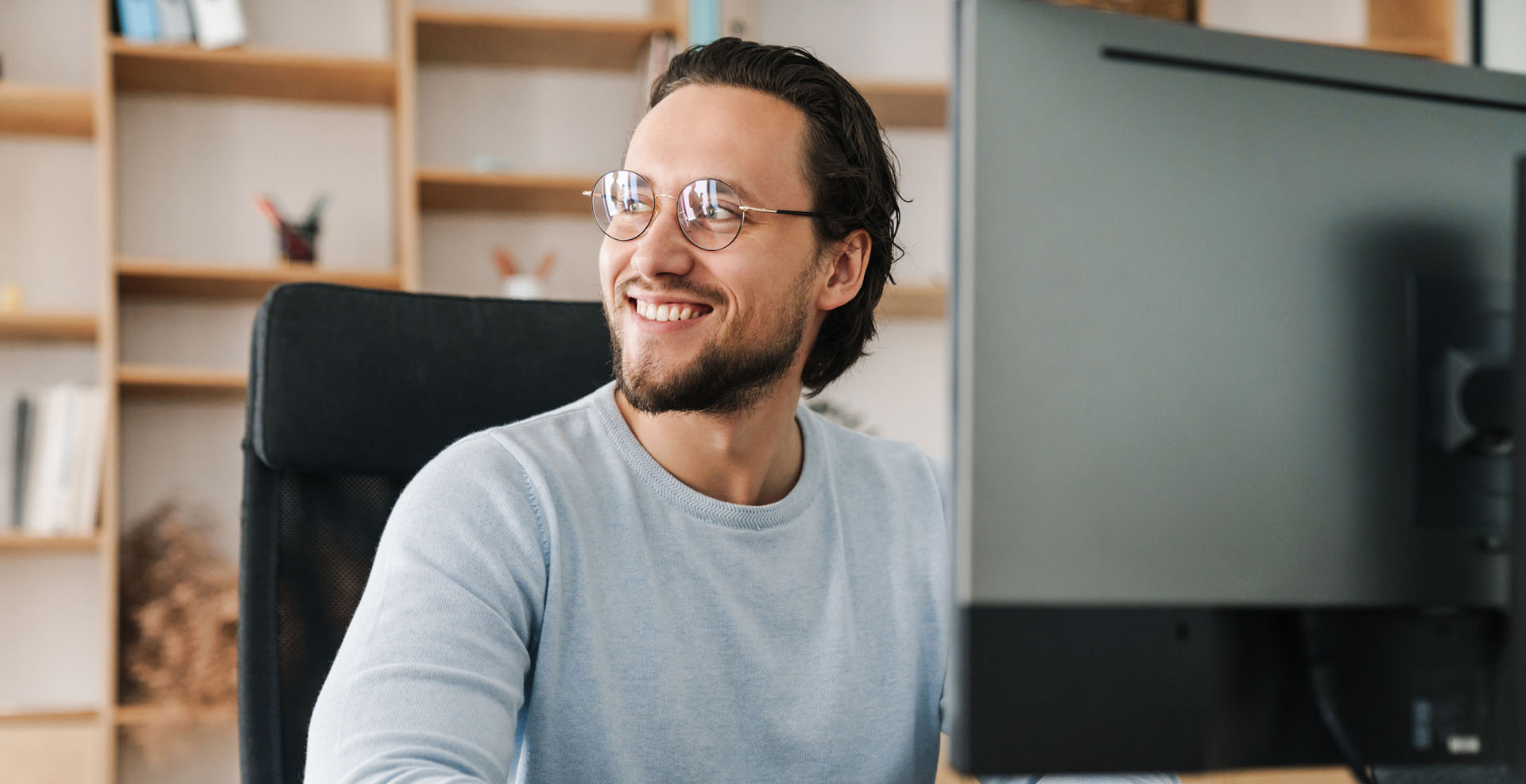 smiling-unshaven-programmer-working-cropped